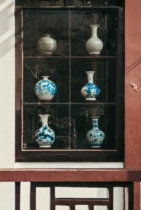 A collection of blue and white porcelain vases displayed in a window in Nanjing, China.